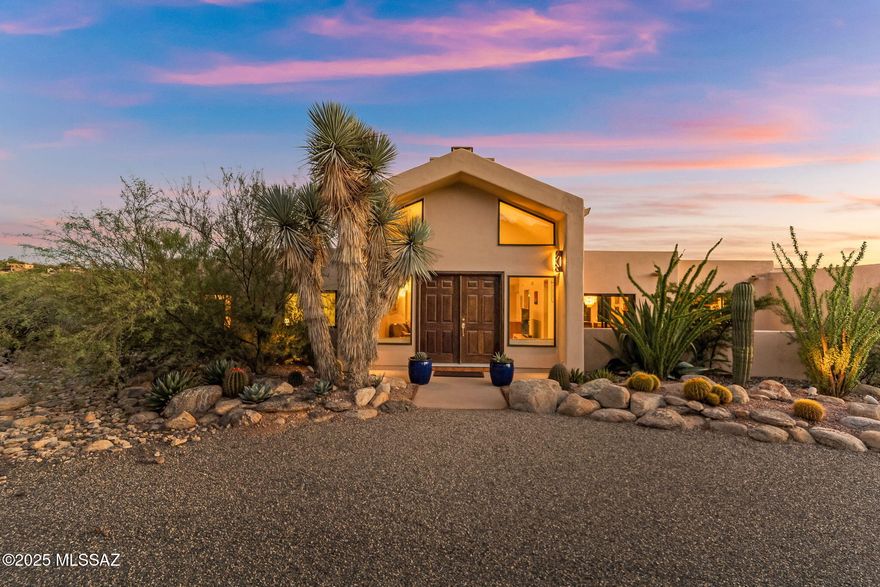 Beautifully kept foothills home in the desirable Sin Vacas neighborhood, featuring a grand entryway framed by mature desert landscaping. Set on a generous .87-acre lot, this 3 bedroom and 3 full baths residence offers mountain views from both the dining room and kitchen areas plus tranquil desert vistas from the private covered back patio. Spacious rooms with high ceilings create an open, elegant feel, with plenty of room for entertaining both indoors and out. Enjoy two fireplaces, one in the living room and one in the family room. The open kitchen with breakfast area, large laundry room, and a 2-car garage add everyday convenience. Take in stunning sunsets and sparkling city lights at night. A fabulous value in the heart of the Catalina Foothills!