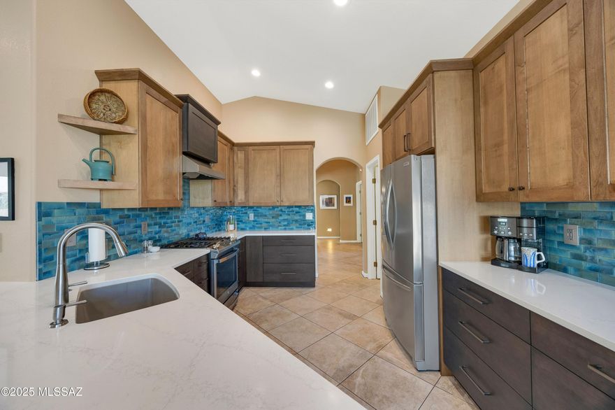 Beautifully Updated Topaz with Mountain Views! Great Curb Appeal & Front Courtyard! Spacious Great Room. Gorgeous Kitchen has Quartz Counters, Tile Backsplash, Stainless Appliances, Gas Range with Vent Hood, Custom Cabinetry, Pantry Cabinet with pull-out, & LED Lighting. Flex Area for your needs. Dining Area with Slider to Patio. Owner's Suite has Bathroom with Quartz Counter, Tiled Walk-in Shower & Walk-in Closet. Guest Bedroom with French Doors, Murphy Bed Office System & Closet. Guest Bathroom with Quartz Counter & Tub/Shower. Laundry Room has W/D & Cabinets. Irrigation System Replaced 2022. Newer Windows, Blinds, & Plantation Shutters. Extended 2 Car Garage has 2019 HVAC, 2020 W/H, Utility Sink, Cabinets, & Side Door. Covered Patio with Lovely Landscaping, Fruit Trees, & Gated Yard!