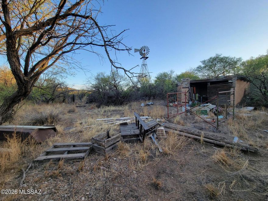 This beautiful lot is RH zoning and .99 acres. The lot has an old rock & concrete building that was probably a tack shed or
workshop. There is also a windmill that sits halfway on the property in the SW corner of the lot. Possible water is available
from the windmill well but buyer to verify that. Electricity close by. There is physical access to the land but Title states it lack
a legal easement / access. Old historic ranch area that gives one the old west feel. Buyer to do own due diligence / research.
Lot sold as is.  Call Pima County for more information.