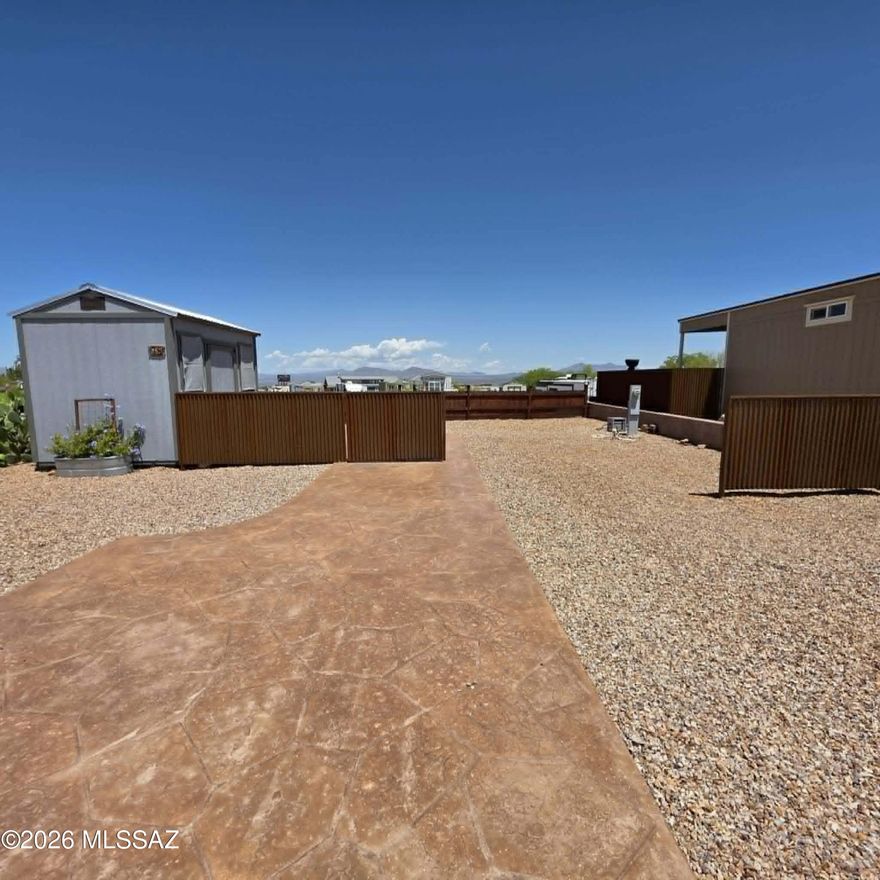 Check out this Corner lot! Welcome home to this great lot located in the 55+ Legends RV Park! Beautiful stamped concrete driveway and sidewalk lead up to the space to place an RV or 5th Wheel. Custom metal privacy fencing keeps the back yard private to enjoy the shed or the space for a Spa.