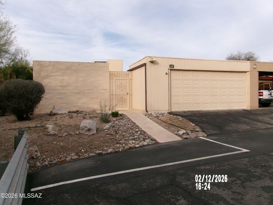 Very nice townhouse in a well administered community, this home features a spacious split 2 Bedroom/2Bath floor plan, large living room with a bee hive fireplace and dining area , a fully appointed kitchen with abundant cabinets and a dinette section.  A full covered patio offering shade all thru the day.  There is an entry courtyard plus a 2 car garage and just  a short walk to the community pool!  Located very close to Udall Park with all shopping and amenities nearby!  Seller has installed a new roof with a five year warranty!