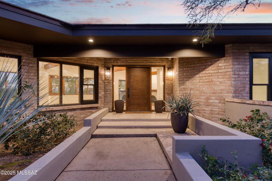 Positioned on expansive land in the heart of the Catalina Foothills, 4740 N Hacienda Del Sol Road offers a rare blend of refined luxury, thoughtful modernization, and sweeping desert views—with voluntary HOA and no CCR's. This exceptional Foothills residence captures the essence of upscale Tucson living, combining privacy, space, and proximity to the area's most sought-after amenities, including world-class dining, shopping, golf, hiking trails, and renowned schools. The home has undergone significant upgrades, with the kitchen and bathrooms fully remodeled to meet modern luxury standards. Designed as both a showpiece and a functional gathering space, the chef's kitchen features granite countertops, a custom breakfast bar, and a premium Viking appliance suite, including a separate refrigerator and freezer, dual ovens, and professional-grade performance ideal for entertaining on any scale. The open floor plan allows the kitchen to flow seamlessly into the main living areas, creating an inviting environment filled with natural light from newly replaced windows throughout the home.

An abundance of natural light highlights the engineered wood flooring, newly replaced in summer 2025, and enhances the home's warm, cohesive aesthetic. Architectural character and comfort are further elevated by two wood-burning fireplaces, which add timeless charm and create inviting focal points in the living spaces.

The primary suite is a private retreat, offering a spa-inspired bathroom finished with luxurious Carrara marble, delivering an elegant, resort-quality experience. Secondary bathrooms have also been tastefully remodeled with high-end finishes that maintain consistency throughout the home.

A highly flexible floor plan includes a fourth bedroom with a separate entrance, making it ideal for guest quarters, multigenerational living, a private office, or studio spacean increasingly desirable feature in Catalina Foothills properties.

Outdoor living is a defining element of this residence. The updated backyard is designed for true Arizona resort-style enjoyment, featuring a sparkling pool, outdoor kitchen, and generous entertaining areas surrounded by mature landscaping. The expansive lot enhances privacy while providing beautiful Foothills views and a strong connection to the surrounding desert environmentperfect for enjoying Tucson's year-round climate.

With its open, light-filled interior, luxury finishes, dual wood-burning fireplaces, expansive land, scenic views, and premier Catalina Foothills location, 4740 N Hacienda Del Sol Road represents a rare opportunity to own a turnkey luxury property that balances elegance, comfort, and lifestyle in one of Tucson's most prestigious settings.