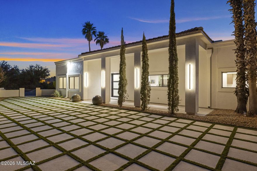 Majestic Oro Valley Country Club Home Perched high on a premium elevated corner lot overlooking the stunning 18th lake hole of Oro Valley Country Club, this fully remodeled masterpiece redefines luxury desert living. With 5 bedrooms, 5 bathrooms, and a large detached guesthouse, this estate offers an exceptional blend of sophistication, space, and versatility.
Step inside to experience a home that has been completely transformed with high-end designer finishes throughout. The heart of the home is a chef's dream kitchen, featuring top-of-the-line Thermador appliances, striking quartzite countertops, custom cabinetry, and expansive prep and entertaining space. Towering ceilings and walls of windows flood the home with natural light while perfectly framing the golf course and mountain views.
The expansive floor plan offers large, private bedroom suites, each paired with beautifully upgraded, spa-inspired bathrooms. The primary suite is a true retreat with direct access to the outdoor living areas--perfect for enjoying serene sunsets and elevated views.
A standout feature is the spacious detached guesthouse --ideal for multigenerational living, private office space, or luxury guest accommodations.