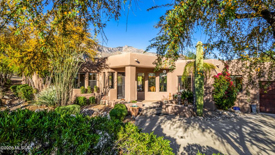 This Southwestern Contemporary captures desert luxury on 1.52 acres with unobstructed mountain views. A custom iron entry opens to a refined 3,157 SF interior with high ceilings and multiple fireplaces. The split floor plan balances social spaces with privacy. The gourmet kitchen features alder cabinetry, granite counters, a Wolf cooktop, and a custom wet bar. The primary suite offers a private sitting room and French doors to the rear grounds.
The outdoors maximizes the mountain backdrop with an expansive porch, pool, putting green, and built-in BBQ. A kiva fireplace with seating completes the desert setting. With seller-owned solar and oxidized iron garage doors, this home offers a sophisticated lifestyle in District 16, minutes from premier shopping, golf, and dining.