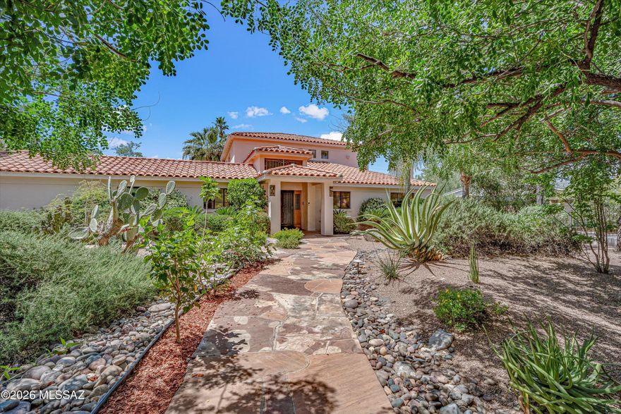 Situated in the coveted historic neighborhood of El Encanto Estates, this must-see luxury residence offers the perfect balance of privacy and modern living in the heart of Tucson. A renovated kitchen features modern appliances and beautiful custom finishes. The spacious family room is highlighted by a seamless indoor/outdoor bar area. The oversized primary suite serves as a true retreat complete with a private balcony. Step outside to your own private oasis in a serene setting with mature landscaping, large ramada with fireplace, and resort-style saltwater pool and spa. This property has a water well, and is listed on the National Historic Registry, providing valuable tax advantages. The premier central location is just moments away from the best amenities that the city has to offer!