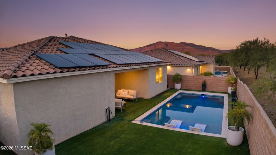 Built in 2020 in the highly sought-after Saguaro Trails community, this beautifully upgraded contemporary residence blends modern design, functional living, and resort-style outdoor spaces. This thoughtfully designed split bedroom floor plan offers 3 bedrooms plus a den/office and open concept spaces filled with natural light and seamless indoor/outdoor living. 
The upgraded kitchen is both sophisticated and functional with quartz countertops, 42'' cabinetry, designer tile backsplash, large center island with a breakfast bar, a walk-in pantry, reverse osmosis system, stainless steel appliances, and a 5-burner gas cooktop with stainless steel hood vent.  Large glass sliders open the great room to the covered patio, that is protected on both sides making it ideal for outdoor living & dining The spacious primary suite offers a luxurious retreat with a double vanity,  an impressive spa-inspired walk-in shower with custom tile, and an oversized walk-in closet. Secondary bedrooms feature ceiling fans and access to a beautifully appointed full bath with double vanity and custom tile finishes. Additional highlights include upgraded hardware throughout, custom window treatments, smart thermostat, big laundry room, a powder room for guests,  extra storage closets, in-ground electrical, a water softener, reverse osmosis, and full interior paint completed in May 2026.
One of the few homes in the neighborhood with a private pool, the backyard was designed for low-maintenance resort living with lush turf, full block wall privacy, protected covered patio with oversized modern fan, app-controlled pool equipment, and a newly constructed pool featuring a baja shelf with in-water lounge seating. Owned solar enhances efficiency and long-term value.
Located within desirable Saguaro Trails, residents enjoy exceptional community amenities including a recreation center, resort-style pool, splash pad, basketball court, dog park, parks, walking trails, and convenient access to shopping, dining, and the growing southeast Tucson corridor.
