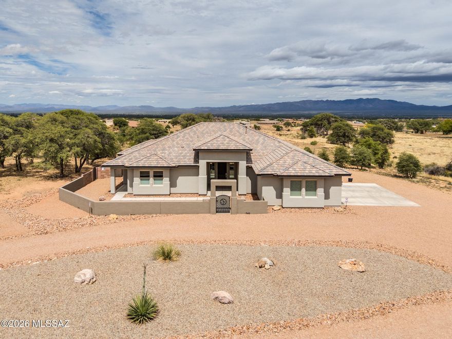 Spectacular custom home recently built in 2022, featuring luxury touches from start to finish. This gem is tucked away at the end of the road on a private lot, in a gated community, surrounded by majestic oak trees and framed by stunning mountain views. Step inside this 4-bedroom, 3-bathroom home to a thoughtfully designed split floor plan with tile flooring throughout, leading into a gourmet kitchen that anchors the heart of the home. Expansive indoor-outdoor living spaces create year-round comfort. Professional landscaping complements the natural beauty of the property, while the oversized garage and owned underground 250-gallon propane tank adds functionality and efficiency. A rare combination of privacy, quality craftsmanship, and breathtaking Arizona scenery!