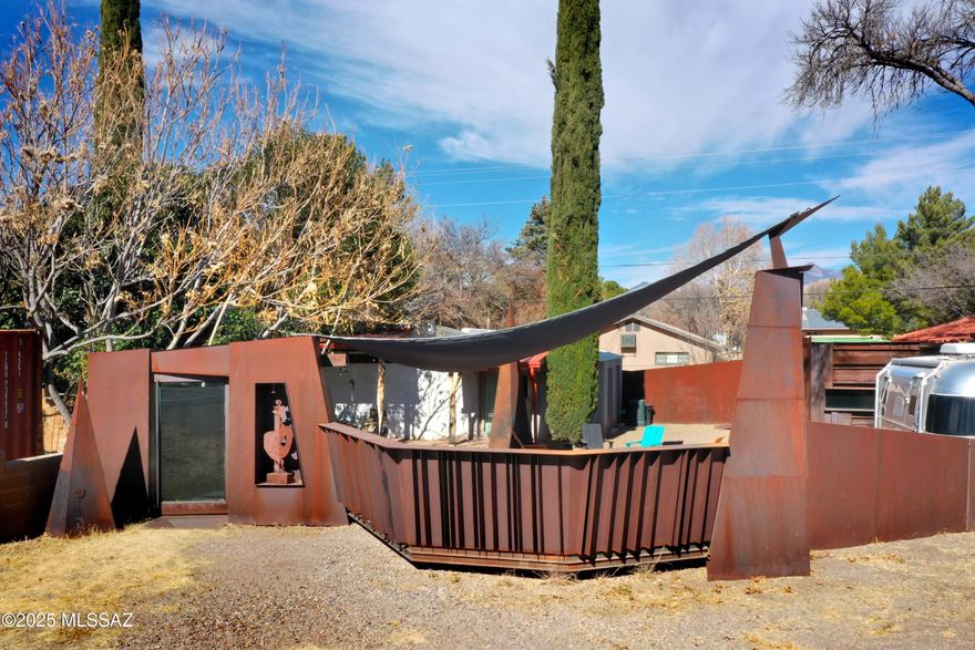 A particularly special Patagonia offering for its heart of the village location; its potential uses (including many varieties of businesses); & for its handsome 1,262sf 1Be/1Ba residence. The home sits at the back of the Lot & enjoys direct access on to Mendoza Alley. The front, which is still undeveloped & ready for another home, business, garden, etc., faces directly on to Naugle Ave! The home's open-plan styling, contemporary flair & premier business location is difficult to come by in Patagonia. 2 points of note~ is that there is room to create a 2nd Bedroom in the home. And separate from the home is the nearby 8'x20' handsomely converted/remodeled 'shipping container'. Its 160sf +/- size is not included in the footage noted for the home.