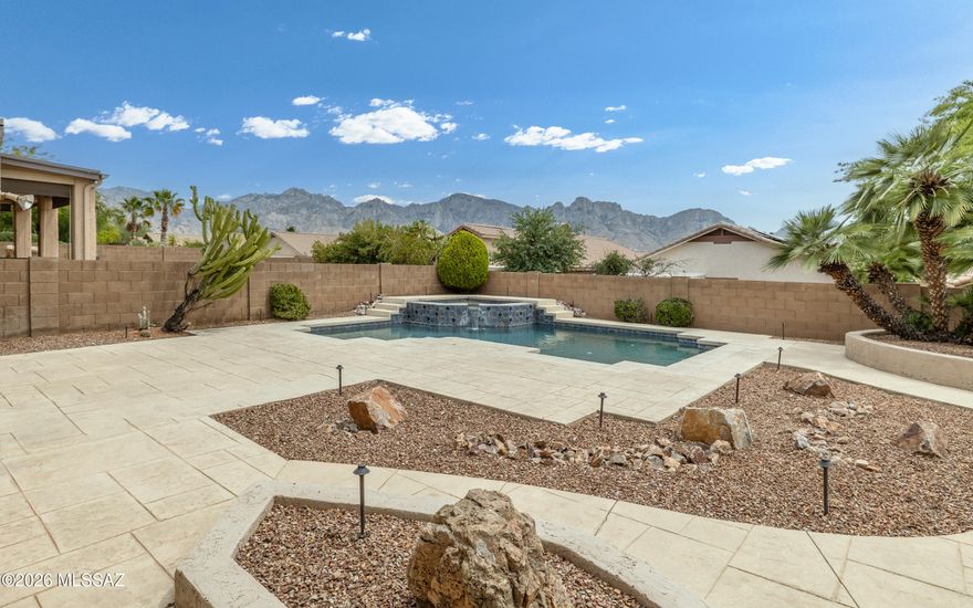 5BR/3BA, 3Car Garage home w/2891sqft built on a Premium lot w/ desirable mountain views of Pusch Ridge & Santa Catalina Mountains. This hand-selected homesite, offers superior views,
increased privacy, and designed for the family with traditional formal dining, gourmet kitchen, and dedicated spaces for entertainment. Custom POOL & Spa with fountain feature is surrounded by a Professionally landscaped backyard and stamped concrete decking, exotic cacti
& palms and low voltage lighting. MANY interior upgrades-Plantation Shutters, SS Appliances, RO Water Purification System under Kitchen Sink, Soft Water System, Crown Molding, decorator touches throughout & More. Ask for Features & Amenities information.