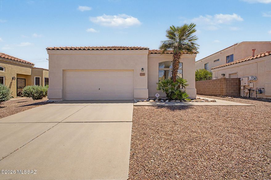This 3-bedroom, 2-bath home with a 2-car garage offers a functional layout with multiple living spaces, solid 8'' stucco construction, and plenty of natural light. Tile and carpet flooring along with ceiling fans throughout create a comfortable feel. The kitchen features ample cabinet space, recessed lighting, and a breakfast bar overlooking the great room with sliding door access to the covered patio. The spacious primary suite includes a walk-in closet and private bath with glass-enclosed shower. Outside, the backyard offers plenty of room to relax, entertain, or customize to fit your needs. Located in the highly sought-after Vail School District and conveniently close to shopping, dining, and more!