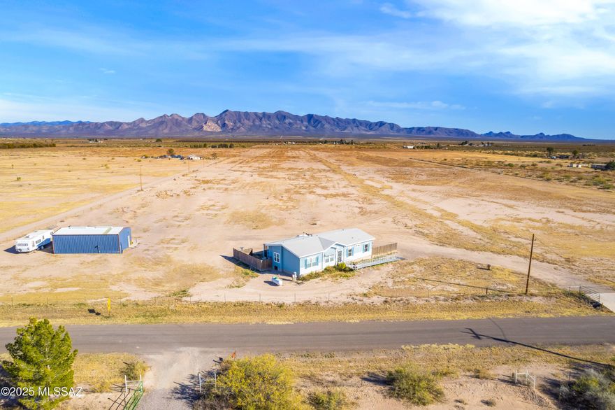 This incredible farm and home property offers the perfect blend of modern comfort and agricultural potential. The home is a gorgeous, newer (2018) manufactured home featuring laminate flooring throughout and charming farmhouse details. The kitchen is designed for both function and style, with a large walk-in pantry, spacious island, and stainless-steel farmhouse sink—perfect for everyday living or entertaining.
Additional interior highlights include a spacious laundry room with ample storage, a pellet stove, and a desirable split floor plan. Step outside to enjoy the impressive 12x37 enclosed and screened patio, ideal for relaxing and taking in the surrounding views. Home is connected to city water. Outside, the property features a 20x40 metal shop complete with 240 volt power, a hot water heater, and a convenient ½ bath, making it ideal for equipment storage, projects, or a working farm setup.
Beyond the home, this 79+ acre property is well-suited for agricultural use. Located within the Douglas AMA, the land includes 60 dedicated acres of water rights. While the property has not yet been farmed by the current owners they have set it up so that it can easily be put into production.

The farm includes mini pivot irrigation systems, designed for efficient water use. Currently in place are one full mini pivot and one half mini pivot. A ¾ mini pivot is also on the property and ready to be built, offering additional expansion potential.

In addition to city water, the property has three irrigation wells. One well is fully functional and ready for use and has been recently serviced with rebuilt and replaced components as needed, resulting in a system that functions like new. Updates include a Simflo pump, column pipe, tube and shaft, along with a natural gas Cummins NG engine, producing approximately 400 GPM. The well depth is approximately 650 feet. Two additional irrigation wells, each approximately 350 feet deep, are also located on the property and are not currently in use.

This is a rare opportunity to own a property with modern living, efficient irrigation infrastructure, and substantial water resourcesideal for agricultural, ranch, or investment use.