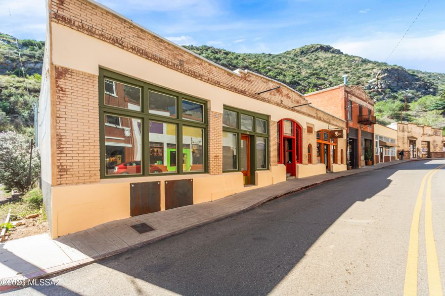 Prime Main Street investment opportunity in the heart of Bisbee within the highly sought-after Bisbee Historic District. This 3,586 sq ft historic commercial building (circa 1900) has been extensively renovated, blending preserved character with substantial modern infrastructure upgrades. Currently configured as three restaurant spaces under one roof. Two spaces are leased to established operators (Taqueria Outlaw and Santos speakeasy), with one large nearly turnkey space available. Flexible potential: vacant space may be converted to residential use (buyer to verify zoning/permits), offering live/work or mixed-use opportunity.  The vacant space includes a 10-ft Type 1 hood with fire suppression, walk-in refrigerator (new cooling system), commercial high heat dishwasher, deck oven, grease trap system, upgraded plumbing and electrical, 200A service, dedicated circuits, new PEX main water line, dual 4-inch PVC waste lines, floor drains throughout, and 3- & 5-ton HVAC units. Custom tile, white oak floors, skylight, bar infrastructure (with water, power, and draft system capability), and quality finishes complete the space. Adjacent to one of the largest free public parking lots in town with strong foot traffic and visibility. Current cap rate 2.12% at 2/3 occupancy. Projected 6.34% at full occupancy (NOI $63,081). A rare opportunity to acquire a historic hospitality asset with modern infrastructure in one of Southern Arizona's most distinctive tourism markets.