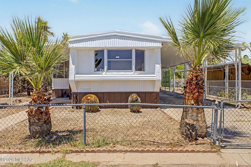 Welcome to this charming manufactured home! This gem features convenient carport parking and a cozy covered patio. Fall in love with the spacious living areas filled with natural light, perfect for entertaining and comfortable everyday living, showcasing wood-look floors and a soothing palette that makes every area feel warm and welcoming. The kitchen features spacious counters, ready for your choice of appliances. You'll love the two sizable carpeted bedrooms, providing ample space for relaxation. The screened-in patio is perfect for enjoying your morning brew and spending relaxing evenings. Out back, you'll have an easy-care landscape and storage sheds for extra organization. What are you waiting for? Come see it before it's gone! Agent/Owner
