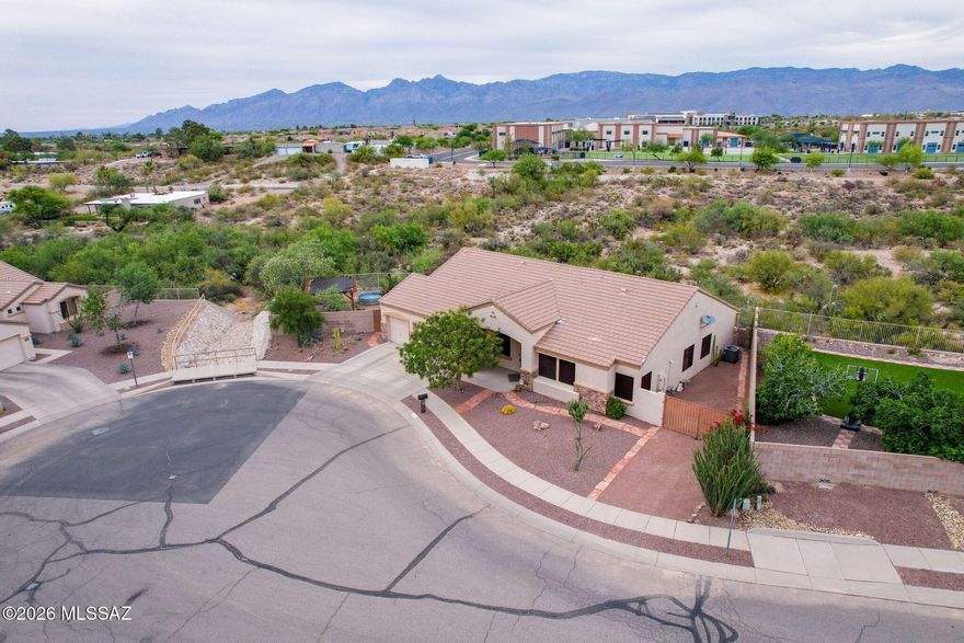 Own your slice of desert living on 1.5 acres taking in views of the Catalinas & Rincons from the privacy of your own backyard w/ over 20 bird species! At the end of a quiet cul-de-sac, offering 2 x 6 construction, cathedral ceilings, FIVE bedrooms, 2.5 baths, w/ a functional split floorplan, your options are endless! Equipped w/ 2 living areas & generous dining space--ideal for everyday living & entertaining. Updated kitchen features custom cabinetry, full slab granite counters, bar seating, wine cooler & stainless steel appliances. Primary suite is upgraded w/ grande shower w/ glass surround, 2 mosaic shower niches, dual vanity, walk in + extra closet, all w/ a private entry to the backyard. Each add'l bedrm has their own deep closet providing smart use of space throughout the home. 3 different byard spaces: secured add'l parking, covered patio, + add'l side yard w/ pavers, pathways, shaded pergola, seating - all privately surrounded by natural desert, views, grilling space and whatever you want to add! Whole-home speaker system w/ surround sound throughout.Extended depth, 3 car garage has ceiling mounted storage shelves, and room for your work space and more. Maintained in and out, this home is move in ready! Don't miss out!