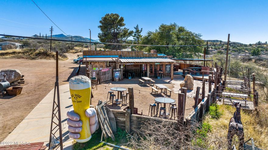 Turn-Key Tavern + Separate Income 
The Ore House Hilltop Tavern offering includes two contiguous parcels forming a complete, income-producing business and real estate portfolio:
The front parcel along Old Highway 77 contains the fully built-out, operating Ore House Hilltop Tavern.
The rear parcel along N. Jefferson Drive includes a stand-alone manufactured home generating rental income.
The tavern is a true destination asset, featuring an authentic interior, dual brick bars, fireplace seating, multiple TVs, gaming, and expansive outdoor patios with panoramic desert and mountain views. 
Highlights
Two-parcel offering: Tavern + separate residential parcel
Operating business with in-place staff
Iconic hilltop location with indoor and outdoor service areas
Ideal for investors