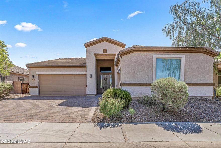 This move-in ready Saguaro Bloom home offers owned solar plus up to 3% in buyer concessions with acceptable offer, creating immediate value and lower monthly utility costs. The versatile floorplan features 4 bedrooms plus a bonus room/den, while a Jack-and-Jill bath connecting two secondary bedrooms adds functionality for family, guests or multi-use living. High ceilings, abundant natural light and an open-concept design create a spacious feel throughout the main living areas and kitchen. Enjoy a fully finished backyard with artificial turf and room to personalize with your favorite plants. Three garage spaces provide exceptional storage. Ideally located across from one of the community parks in Saguaro Bloom with access to pools, walking paths and neighborhood amenities.