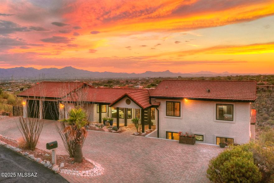 Stunning home located in exclusive Sin Vacas neighborhood, offering breathtaking Catalina, Tucson Mountain & city views. Every aspect of this home has been touched & improved making this generous 3,960 square gem perfect for comfortable living & entertaining. Situated on a 1.3-acre lot this home features 5 bedrooms & 4.5 bathrooms that have all been tastefully remodeled to offer a modern & luxurious living experience. Step inside to discover new flooring throughout the home, creating a fresh & long lasting contemporary look. The addition of new doors, windows, & garage doors in 2022 enhances the overall aesthetic & provides improved functionality. This home also boasts updated heating, ventilation & air conditioning (HVAC) systems + 2 new hot water heaters... installed in 2022, ensuring optimal comfort and efficiency. Additionally, the installation of new owned solar panels in 2022 combined with low E windows results in $10 average electric bills. The kitchen has undergone a stunning remodel, featuring new backsplash, appliances, quartz countertops & cabinets. These upgrades offer both functionality & style, making it a chef's dream come true. The home has been equipped with new window treatments, including motorized shades in the living & family rooms, allowing for effortless light control & privacy. Stacking doors have been added to create a seamless transition between indoor & outdoor living spaces, perfect for enjoying the beautiful surroundings. The exterior of the home has been freshly painted in 2023, providing a polished & updated appearance. With a transferrable 10-year warranty. Additional features include Catalina rip rap at the front of the home, a paver driveway, repainted interior doors, new turf installed in yard & 8x8 exterior wood pillars. These enhancements add to the overall curb appeal of the property. This beautiful masonry built home offers a blend of modern upgrades, luxurious finishes & stunning views, creating an exceptional living experience in the coveted Sin Vacas neighborhood. Welcome Home!