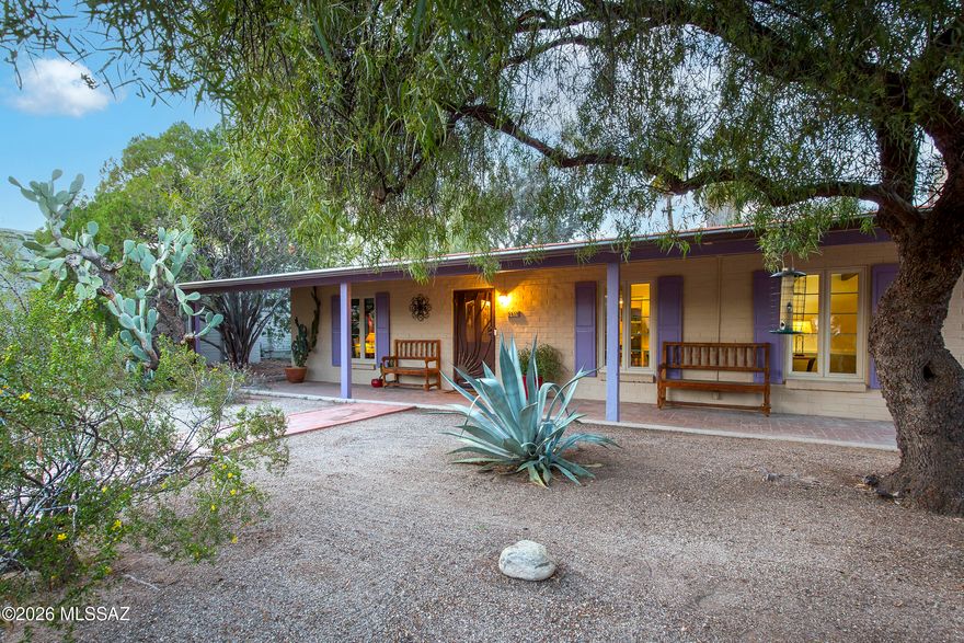 INCREDIBLE HISTORIC JOESLERESQUE STYLED RESIDENCE in the Coveted Central Oasis, El Montevideo Estates. Thoughtful attention to detail has been painstakingly dedicated to preserve the home's original character and architectural elements. Mid-Century charm abounds, plus enjoy proximity to all mid-town amenities- shops and restaurants. Home blends modern comforts with the refined character found in classic Tucson homes. Lovely pine beamed ceilings in living areas, Wood Burning Cone Shaped Fireplace, Secondary BR's share a Large Jack-N-Jill Bath with Classic Original Tile. Recent upgrades include a Newer Roof, Newer Ceramic Tile in all traffic areas, a Newer HVAC, Custom Security Door, + Rainwater Harvesting. Gorgeous 2024 Kitchen Remodel with New Cabinets, Quartz Counters, and New Appliances. The Gourmet Kitchen also offers a Pot Rack, Exposed Brick above the stove, and a Butler's Pantry. The Kitchen area flows into the Outdoor Patio area #1 with Brick Pavers, Outdoor Dining Area, Rainwater Harvesting, and Gutters connecting to the Rainwater Harvesting tank added. High Adobe Walls, Mature Trees, and Desert landscaping treat your guests to a "Blue Willow" like Patio Space. 

In the backyard, your guests will be surprised and delighted by the "Cantina De Jesus," which looks straight out of a movie set, but actually provides the homeowner with numerous outdoor storage areas and workshops. Could be potential for a guest house or casita- one would just need to add plumbing. (Electrical is already there). Workshop area has 220V- great for projects. Also a potting shed and numerous creative outdoor spaces- limited only by your imagination. 

Additional upgrades to the home include- All windows were replaced by Tucson Window and Door. Electric Box was upgraded in 2007. New Gas Meter and Water Meter. Water Heater replaced in 2019. Split System HVAC- front unit replaced in 2021- back unit replaced in 2020. ADT Home Security System with Security Cameras (Stays). Breezeway connecting wings of the house with stained concrete flooring. Primary Suite Wing was a previous addition and is Burnt Adobe construction, and contains the Primary Bedroom, Laundry + Storage. The Primary Bath was Remodeled with a Walk in Shower, and is spacious and bright. The primary wing also offers a separate Executive office space (or 4th bedroom) with wood plank floors, exposed adobe,  wood beams, and an old fashioned cast iron corner pot belly stove (stays). Entire house has numerous period built in cabinet and secret storage nooks/additional storage spaces. (When visiting check behind shuttered doors). The driveway has room to add on a single car, tandem carport. 

The backyard is a zen oasis with patio #2- a brick sitting area among tall mature trees, an outdoor brick fire pit, and a lovely metal ocotillo ribbed fencing. The beautiful backyard provides a peaceful oasis, and is also pool sized. 

This home was originally custom built for the former president of Valley National Bank. A rare offering in the classic El Montevideo Estates Community- it is a true Tucson treasure, with the money saving benefits of Historic tax status. The property also has one of only 57 remaining original Truly Nolen termite warranties from 1969. 

You'll love this location: it's just a short stroll to Locale for morning coffee, weekend brunch, or an elevated dinner. Midtown restaurants and shopping are minutes away, and the historic Sunshine Mile district is also close at hand. The home sits just 2.5 miles from the University of Arizona, and only 3.5 miles from downtown- offering quick access to everything from arts and culture, to major medical and employers.

Less than half a mile away is Gene C. Reid Park, Tucson's iconic recreation hub: run or walk the scenic 2-mile path, play one of two 18-hole golf courses, visit the Reid Park Zoo, wander the rose garden and duck pond, or take your dog to Miko's Corner Playground for off-leash fun. The Edith Ball Adaptive Recreation Center offers year-round swimming and wellness programs.

Welcome to your own Tucson Historic, Mid-town Oasis, where all the work has been done. Here, in the midst of a shaded Eucalyptus grove- you will find the perfect place to begin your next chapter!