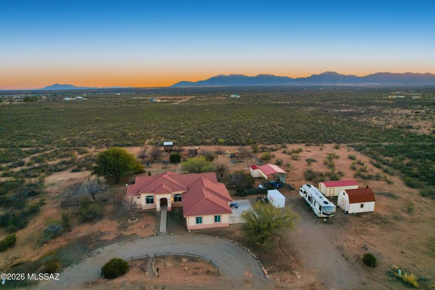 4 ACRES • MOUNTAIN VIEWS • NO HOA • ROOM FOR ALL THE TOYS  If you've been craving space, sky, and that true country-homestead feeling -- this is it. Set on 4 usable acres with mountain views in every direction, this lovingly cared-for property delivers the kind of lifestyle people move to Arizona for. Mornings start with wide-open horizons. Evenings end with sunsets that go on forever. Inside the 2,300 sq ft home, western character meets comfort. Warm architectural touches like a beehive fireplace, wood posts and beams, and inviting living spaces create that grounded, ''home has a story'' feeling the moment you walk in. The layout offers 3 bedrooms, 3 baths, plus a den -- flexible space for an office, hobby room, or guest overflow. tep outside and you've got your own mini-homestead:
* Orchard with fruit & nut trees
*Room to breathe, garden, roam, or simply enjoy the quiet
*NO HOA - bring your plans, your projects, your lifestyle
Need storage? You're covered.
*Oversized 3-car garage with room for ATVs, workshop space, and serious storage
*Covered parking with electricity for RV hookup
*Storage, storage, stor