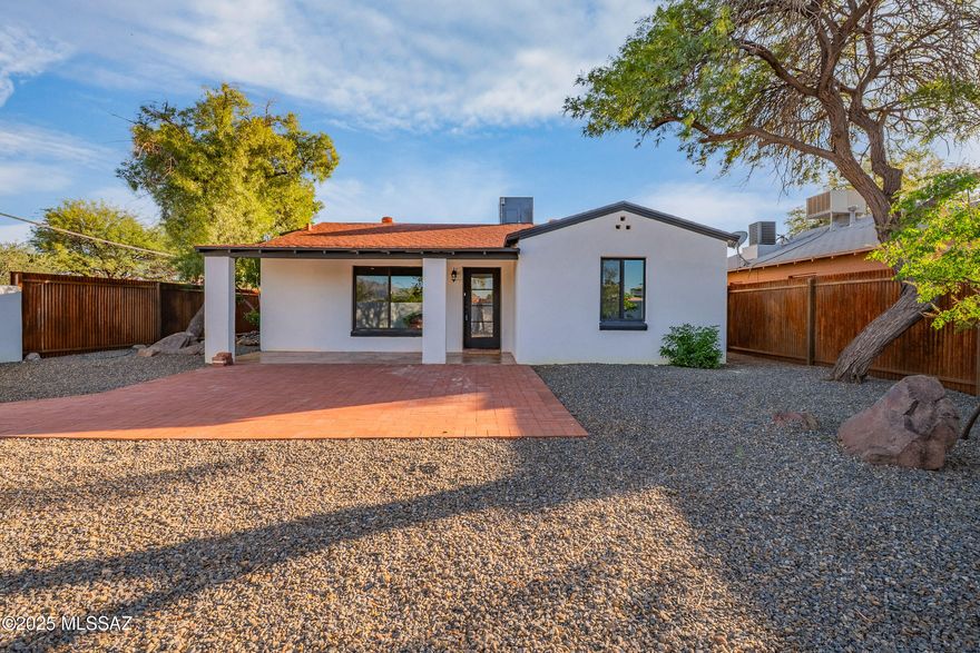Stunning Spanish-style home with 3 bedrooms and 2 bathrooms featuring extensive upgrades throughout and new 2 car garage. The spacious kitchen boasts Taj Mahal granite countertops, tiled backsplash, and a walk-in pantry with abundant storage. Beautiful new concrete overlay flooring flows throughout the home. Luxurious bathrooms showcase tiled shower walls. Major updates include a new roof, new HVAC system, and freshly plastered pool with new equipment. The paved front yard and new metal corrugated fencing enhance curb appeal. Bonus. Move-in ready with modern finishes and investment potential! A Added garage for OFF the street parking, hard to find in this neighborhood.