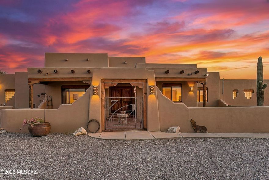 This spectacular Sonoran Desert Estate perfectly blends luxury living with premier equestrian and hobbyist facilities. Set atop a hill, the 360 degree mountain and city views are one of a kind. This warm, well-cared for three bedroom, four bathroom home has a split bedroom plan and beautiful beamed ceilings throughout. The primary bedroom welcomes you with a lovely beehive fireplace, separate sitting area, walk in closet and a lovely private bathroom. The kitchen boasts custom cabinetry, a breakfast bar, fireplace, granite counters and a huge copper sink. An expansive walk through pantry connects the laundry room, kitchen and the attached two car garage. Transition seamlessly through any of the rear doors to a backyard paradise featuring a sparkling pool, relaxing spa, and a rare, lush... expanse of saguaros and real grass. Located steps away is a massive 1,900-square-foot detached workshop/3 car garage/RV garage, perfect for car restoration, heavy machinery, or a commercial-grade studio. This fully finished area with a half bath, extra storage area, 3 sinks, 2 garage doors and RV height ceilings could be kept as is or easily converted to a large ADU. Down a small hill you are greeted with a gorgeous four-stall barn perfect for keeping your horses cool and comfortable. A dedicated, secure tack room stores all your saddles and gear while expansive turnout areas allow ample room for exercise and training. Don't miss your chance to call this magnificent property your forever home!