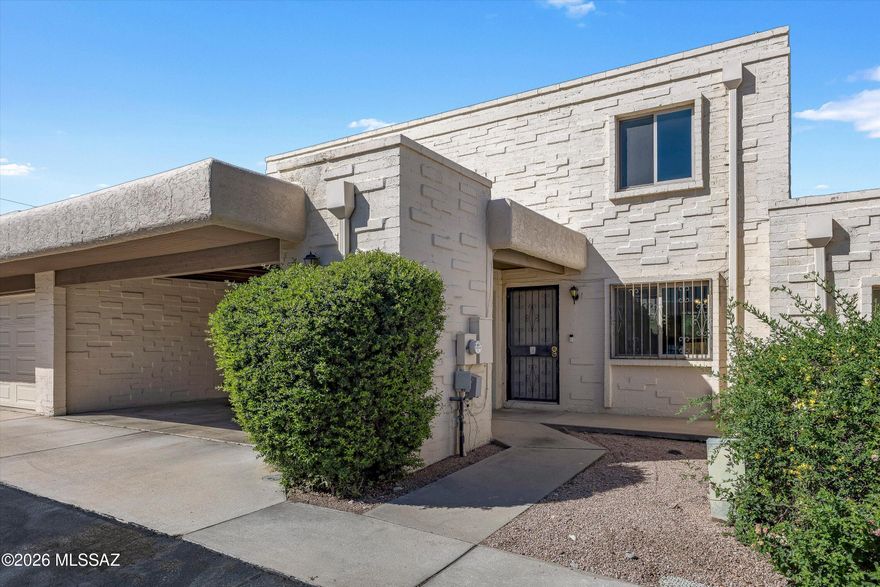 Beautifully maintained 3-bed, 2-bath townhouse in central Tucson offering rare privacy with natural wash views and no direct rear neighbors. Recent updates include dual-pane windows, 2020 A/C, brand-new water heater, and roof with transferable 2-year warranty. Functional floor plan features a downstairs primary suite with walk-in closet and private screened-in patio retreat. Upstairs bedrooms showcase mountain views, while the covered back patio is perfect for relaxing or entertaining. Ideal as a primary residence or investment property, conveniently located near parks, shopping, dining, and everyday amenities.