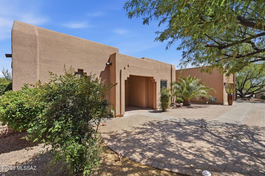 This is a gorgeous Pearce Construction home that is quality built and ideally located in the heart of the active adult community of Green Valley. Recently recoated, the roof offers years of worry-free living, while the freshly painted interior provides a clean, updated feel throughout. Tucked away in the back of the desirable Portillo Hills II subdivision and backing to the natural desert, the setting delivers both privacy and tranquility. From the moment you arrive, the home's curb appeal stands out with its beautifully landscaped, walled front yard and gently curved driveway leading to a spacious two-car garage that accommodates both your vehicles and storage needs. Despite its peaceful setting, you are just minutes from shopping, dining, entertainment, and recreation centers, giving you the perfect balance of convenience and retreat. Step through the front foyer and into a welcoming living room where soaring ceilings with exposed wooden beams and a combination of high and low windows fill the space with natural light. Two sliding glass doors seamlessly connect the indoors to the backyard, inviting in fresh air and enhancing the home's open, airy feel. Just off the living room, a versatile den or office offers the flexibility to create a space tailored to your lifestyle. Adjacent to the living area, the bright breakfast nook features a charming bay window and direct access to the backyard, making it the perfect spot to start your day. The kitchen is both stylish and functional, featuring granite countertops, abundant cabinetry, and sleek stainless-steel appliances that will impress any home chef, while two skylights continue the theme of natural light throughout the space. A multi-purpose room located between the kitchen and garage includes a built-in desk along with upper and lower cabinetry, ideal for hobbies, organization, or a home workspace. The spacious primary suite serves as a private retreat, complete with a sliding glass door that opens to the backyard perfect for enjoying cool desert evenings or stepping out under the stars. The en-suite bathroom offers dual vanities, expansive mirrors, a walk-in shower with a glass block wall, and a spa-like atmosphere designed for relaxation, while a large walk-in closet provides ample storage and organization. The split floor plan ensures privacy for guests, who will appreciate the generously sized guest bedroom and nearby bathroom featuring a large vanity with cultured marble countertops, a full mirror, and a tub/shower combination for both quick mornings and leisurely evenings. Out back, the covered patio is designed for comfort and entertaining, with brick pavers extending beyond into the open yard to create multiple seating areas where you can take in the beautiful views of the Santa Rita Mountains, including Mount Wrightson and Mount Hopkins, providing a stunning natural backdrop. With plenty of room for outdoor furnishings and gatherings, this backyard truly embraces the Arizona lifestyle where sunny days and star-filled nights become part of your everyday experience making this exceptional home the perfect blend of quality construction, thoughtful design and a location that offers both serenity and convenience in one of Southern Arizona's most sought-after communities.