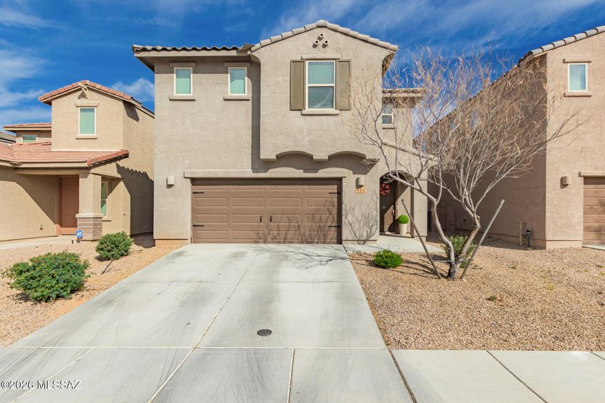 Nestled in the coveted Madera Highlands neighborhood, this beautifully maintained 4 bedroom plus loft, 2.5 bath home offers over 2,340 square feet of warm and inviting living space. A bright great room with soaring ceilings and abundant natural light flows seamlessly into the modern kitchen, complete with stainless steel appliances, gorgeous granite countertops, ample cabinetry, a charming dining area, and a large island with breakfast bar that is perfect for everyday living and effortless entertaining. A convenient powder room is located downstairs for guests. The spacious primary suite provides a private retreat, featuring a luxurious en suite bath with dual vanities, a large walk-in shower, and a generous walk-in closet. Three additional guest bedrooms and an upstairs loft offer flexibility for a home office, media room, or play space. Step outside to a relaxing covered patio with custom extended pavers and low maintenance artificial turf designed for year-round enjoyment. Residents of Madera Highlands enjoy wonderful community amenities including a park, pool, basketball courts, and tennis courts. This is truly a must see home!