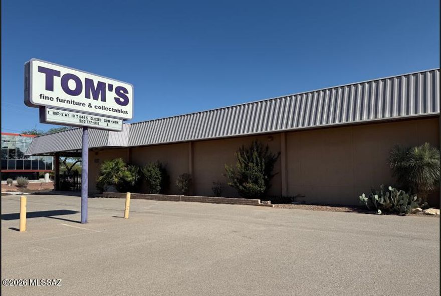 A free-standing, 9,894 square-foot, strategically-located building recognized as the longtime home of the vintage retailer Tom's Fine Furniture and Collectibles!  Recent improvements include: Entire NEW roof installed within the last three months for $25K; 2 newer HVAC units; Newly repaved front parking area; new store sign with LED lighting; new wrought iron fence & gate; new front doors; rolling shutters installed; entire exterior painted by Paint Kings.  47 parking spaces!  The entire building has fire sprinklers.  The rear fenced yard has ample parking.  The upstairs mezzanine can be used for office space or storage, and there is a lift up to the mezzanine deck.  New kitchen cabinets, a new sink, & a new  refrigerator & dishwasher!  See Documents for more property information. See More City of Tucson says that the current Grant Road construction happening in front of the store should be completed by the end of August, early September, 2026. A private, registered well exists on the property.  Contact LA's for information.