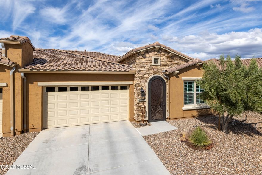 Luxurious upgraded Viva model in SaddleBrooke Ranch! 2021-built 2BR/2BA Villa with a den ! 1,655 sq ft of premium features. Chef's kitchen boasts 41'' upgraded cabinets, crown molding, quartz counters, Blanco sink, and upgraded backsplash. PARADIGM luxury vinyl flooring with plush bedroom carpet. Master suite features rain glass shower, comfort height toilets, walk-in closet with built-ins. Smart home amenities include dimmer switches, USB outlets, TV mounts. Outdoor paradise: extended arroyo (rare!), paver patio, turf courtyard, gas stub, rolling shades. Garage has Outdoor Creations coating, utility sink, custom storage, golf cart outlet. Home boasts upgraded appliances, plantation shutters, security doors. Perfect 55+ lifestyle!
