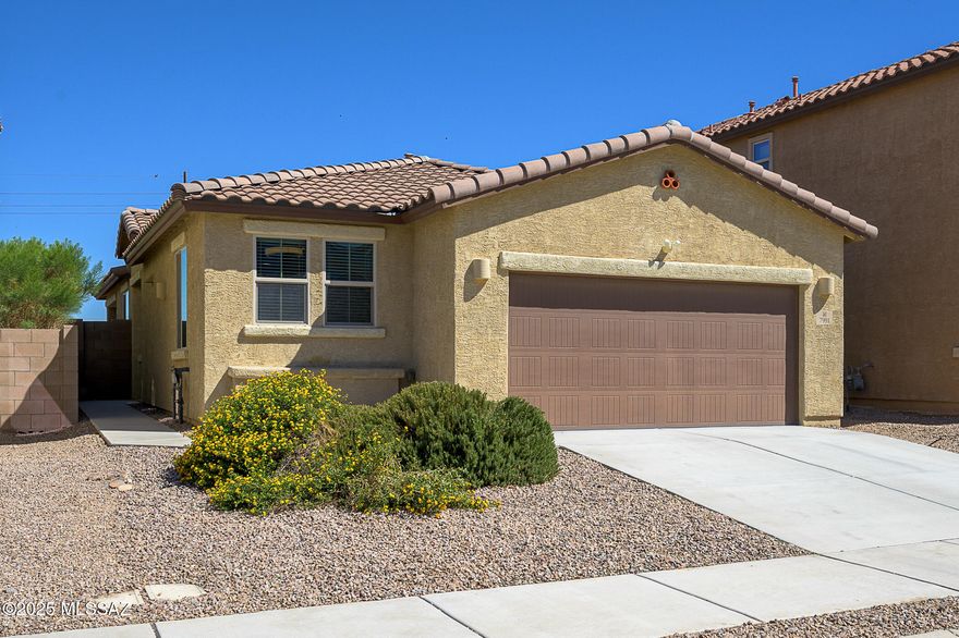 This is the nearly new, well maintained home you've been waiting for!  Step inside to vaulted ceilings and a gourmet kitchen featuring a 5-burner gas cooktop, double oven, upgraded cabinetry, and ample counter space. Home features PAID OFF solar panels to keep monthly costs low, and decorative custom steel doors at front and patio.  

Relax or entertain in the beautifully landscaped backyard, complete with paver patio, low-maintenance turf, and a built-in BBQ/cooktop — perfect for Arizona evenings. Thoughtful upgrades everywhere and all appliances included: new dishwasher, brand new washing machine, dryer, stainless refrigerator.  

All this and located within the award-winning Vail School District, close to DMAFB, and home has 2.9% assumable VA loan!