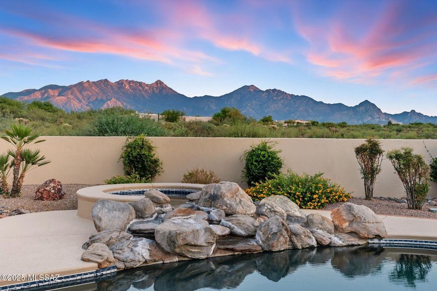 ONE-OF-A-KIND DESERT OASIS WITH  A MAJESTIC MOUNTAIN BACKDROP! Framed by the dramatic beauty of the Santa Rita Mountains, this extraordinary property offers a rare combination of privacy, luxury, and lifestyle amenities. A newly completed $42,000 circular concrete driveway provides an impressive approach to the home and its attached 4-car garage, fully outfitted with built-in storage cabinets, a utility sink, central vacuum, and water softener. Beyond the home itself, the property is enhanced by a brand-new 2,000 sq. ft., 5-car detached garage and shop—valued at over $250,000—offering exceptional quality and versatility. It's fully equipped with a new HVAC, a private office & bathroom, it's a dream space for hobbyists or collectors. Car enthusiasts will also appreciate the negotiable a lift, while a 2018 Yamaha fuel-injected golf car is available under a separate bill of sale. To ensure lasting privacy and preserve the panoramic mountain setting, surrounding lots are also available for purchase. Inside, thoughtful design meets everyday comfort with two Jack-and-Jill bedroom suites, each connected by a private studyideal for homework, reading, or quiet retreats. The primary suite exudes elegance and warmth with its own fireplace, while a second fireplace enhances the inviting family room. A dedicated home gym with private shower adds flexibility, and entertainment shines in the custom theater room, outfitted with all-new electronic equipment for the high-end movie system. A new whole-house intercom system provides seamless communication throughout, complementing the home's modern upgrades. Music flows room-to-room with ceiling speakers throughout the homeand out onto both  patios. Step outside to enjoy a true resort setting: a sparkling pool with spa and waterfall, framed by new cool decking, freshly grouted water features, and brand-new equipment including a 3 HP pump, motor, cartridge filter, salt chlorine cell, and Atlas suction cleaner. Lush new landscaping blends with mature trees, while a private putting green and observation deck create endless opportunities for fun, leisure, and star-gazing under Arizona skies. Expansive covered patios are ideal for entertaining family and friends.

Every detail of this home has been carefully updated to ensure comfort and confidence for years to come. Three new Rheem HVAC systems with smart thermostats keep the home perfectly climate-controlled, while high-end KitchenAid appliances, including a $13,000 refrigerator, elevate the kitchen experience. A Kinetico water system with reverse osmosis provides pure convenience, complemented by refreshed LED lighting, ceiling fans, exterior paint, and roof updates.

This property isn't just a homeit's a private desert retreat designed for living, entertaining, and creating memories. With breathtaking mountain views, top-tier upgrades, and unparalleled privacy, it's a one-of-a-kind offering in Southern Arizona.