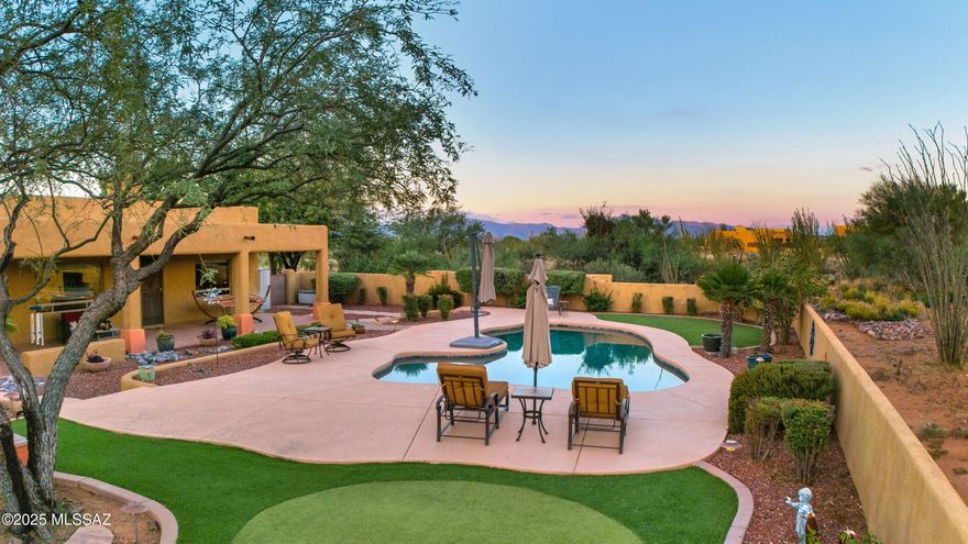 A magnificent, custom homestead rests on 4+ acres in the hills of Vail. Thoughtfully upgraded & with true Southwestern charm, this impressive property greets you with a paved circular driveway, courtyard entry & covered front porch. Because the stunning mountain & desert panoramic views weren't enough, the back of this home is equipped with pool, expansive patio, built-in fireplace & grill, firepit, putting green, and huge, fenced separate side yard w/ RV gate. Inside, discover an abundance of living space with the living, family & bonus rooms. A gourmet kitchen at the heart of the home and a true split floorplan. The primary suite features private entry from the back patio, large walk-in shower and closet with built-in closet system. Extra storage in the laundry and garage. A must see!