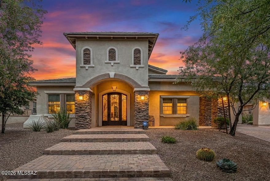 Located within the exclusive gated enclave of Hacienda Del Lago in Rancho Sahuarita, this remarkable semi-custom home offers a rare opportunity to own in one of the community's most private and sought-after neighborhoods, where homes seldom become available. Just steps from the lake, fitness center, tennis courts, water park, and premier amenities, the lifestyle here is as exceptional as the home itself.
Set among only 18 distinctive residences, this one-of-a-kind property is a true standout gem, blending elegance, thoughtful upgrades, and refined comfort throughout. A stunning iron entry door welcomes you in, complemented by brick-accented stairs, soaring ceilings, and a light, bright, and airy ambiance that flows seamlessly from room to room. The grand entrance is enhanced by a partially covered brick driveway, offering both architectural charm and additional parking. Inside, the home features a highly desirable layout, including a private en suite bedroom in addition to the luxurious primary suite. The primary retreat showcases an updated soaking tub, a beautifully tiled glass walk-in shower, and spa-inspired finishes. Every bathroom throughout the home has been upgraded with custom tile work, adding a cohesive and elevated design.
At the heart of the home, the kitchen is a true showstopper, an outstanding centerpiece designed to impress. Crisp white cabinetry, upgraded granite countertops, and premium stainless steel KitchenAid appliances create a space that is both functional and visually stunning, with abundant storage and thoughtful design at every turn. Upgraded lighting throughout the home further enhances its modern, polished feel.
The spacious laundry room mirrors the kitchen's design with matching cabinetry, a utility sink, generous folding space, and a window overlooking the backyard, bringing both beauty and practicality together.
The garage offers a 4-foot extension, ideal for additional storage, hobbies, or accommodating larger vehicles. Outdoors, the backyard is designed for both relaxation and play, featuring low-maintenance artificial turf and an in-ground trampoline, creating the perfect environment for entertaining or everyday enjoyment.
This exceptional property delivers a rare combination of luxury, location, and uniqueness. Welcome home