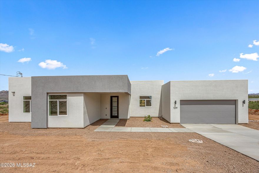 SELLER WILL CREDIT BUYER $5,000 TOWARDS LANDSCAPING! ONE of 3 residences by TAC Architects currently available in the area.

Tucked away for added privacy, this 2026 modern new construction in Rio Rico offers a refined balance of seclusion and design. Created by TAC Architects, the home features 3 bedrooms, 2 bathrooms, and a bright open-concept layout with sleek finishes and abundant natural light.

The expansive backyard captures surrounding views and is well-suited for both relaxation and entertaining, complemented by a private entry that enhances the home's sense of quiet retreat, just minutes from highway access.
