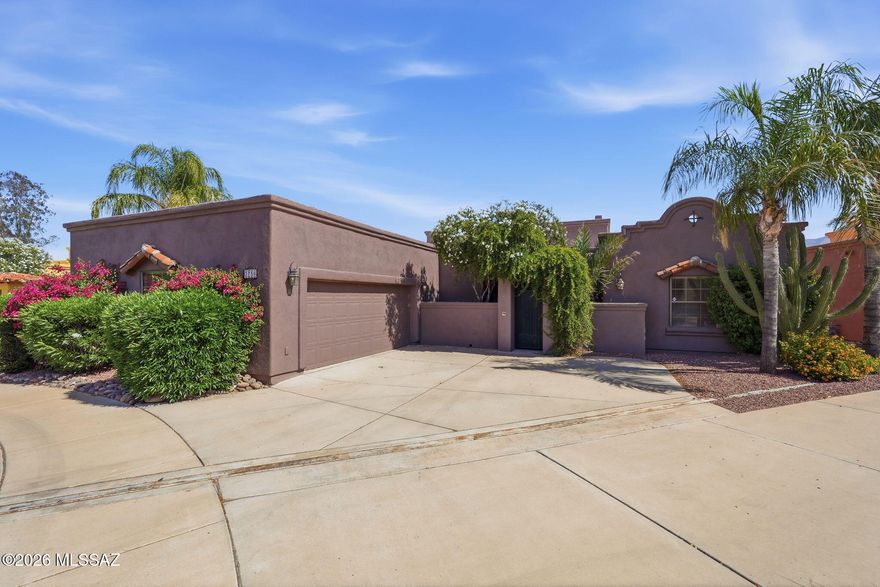 Welcome to this stunning 4-bedroom, 3-bath Santa Fe-style home in the gated Rancho Reposo community! Built in 2004, this single-story residence offers 2,090 sq ft of beautifully designed living space featuring a spacious great room with beamed ceilings, a gas fireplace, and polished concrete floors. The kitchen shines with granite tile countertops, stainless appliances, a walk-in pantry, and an island perfect for entertaining. Enjoy a serene backyard with desert landscaping, mature trees, and a covered patio. Located on a quiet cul-de-sac with north/south exposure, this home includes a 2-car garage and easy access to shopping, dining, and the University of Arizona.