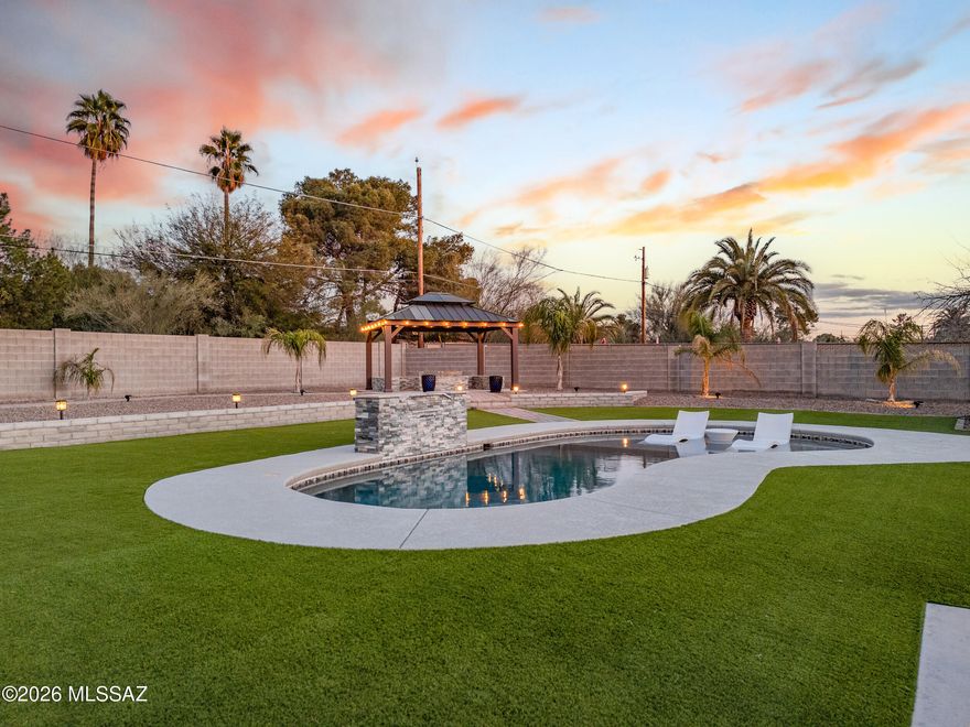 Welcome to one of Central Tucson's most exceptional offerings-set behind walled, elevated, and gated grounds that create rare privacy and presence. This 3 bed, 3 bath home with a 2-car garage blends timeless design with resort-style living. Inside, thoughtfully curated interiors deliver warmth, flow, and function with beautifully designed living spaces ideal for everyday comfort and entertaining. Step outside to a true backyard beach-style oasis featuring a sparkling pool,fire pit, lush turf, ambient lighting, and multiple lounge areas--perfect for sunset gatherings or quiet evenings under the stars. All of this just minutes from Tucson's best dining, shopping, entertainment, and cultural amenities. A gem that feels like a private retreat while keeping you close to everything tucson offers