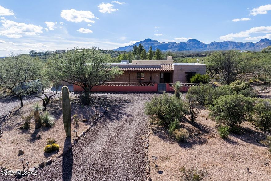Nestled on a little over an acre with no HOA to limit your vision, this 3-bedroom, 2-bath home gives you the kind of flexibility that's hard to find. The setting is classic Tubac with open sky, mountain views that don't quit, and enough open space around you to feel private without feeling remote. Exterior spaces offer room for gardening, hiking and hobbies, with walled courtyard and plenty of covered hardscape for al fresco dining and entertaining. Sheltered entrance opens into an expansive interior filled with warm, natural lighting. Design details include exposed beam ceilings, tile and hardwood flooring, kiva-style fireplace, built-in bookshelves and an open-concept floorplan. Generous kitchen features a seated bar for casual dining, upgraded appliances and dedicated office space.