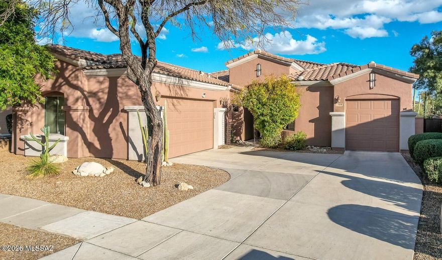 Rarely available 4 Bedroom/3 Bathroom home in gorgeous, Guard-Gated ''Villages at La Paloma''.  Features that sought-after 3-Car Garage, no interior steps & a private, tranquil setting. Premium lot offers equally stunning mountain and desert VIEWS! Expansive professionally landscaped rear yard expands to 140' wide at rear fence, bordering a gorgeous riparian area loaded w/ majestic Saguaro Cacti. Interior features a versatile split-floorplan, high ceilings, separate family/living rooms, a spacious modern kitchen & a generously sized primary suite. Ideal Foothills location just 3 minutes from La Encantada Shopping/Dining & La Paloma Country Club! Nearby Community Pool is a beauty! Freshly painted exterior plus newly installed Water Softener & R/O. Award winning District 16 School