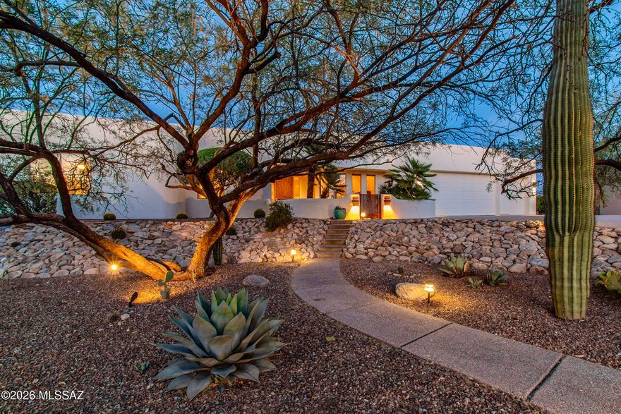 Set within the coveted northeast area of Winchester Ranch in Tucson, this exceptional desert residence captures the essence of refined Arizona living. Situated on a private lot with thoughtful northeast positioning for year-round outdoor living and energy efficiency, the property offers breathtaking panoramic views of the Santa Catalina Mountains, including iconic Thimble Peak, and the Rincon Mountains. The home's striking curb appeal is undeniable, enhanced by a canopy of scaffolding mesquites, fresh exterior paint, aggregate concrete walkways and driveway, and a fully enclosed front courtyard for observing stunning sunset views. Designed for seamless indoor-outdoor living, five separate walk-outs invite you to experience the resort-style living and multiple outdoor entertaining spaces. The back yard features a Pebble Tec pool with a lagoon, built-in bench, KoolCote decking, and a premium self-cleaning Baja Spa set within flagstone. Entertain effortlessly with a built-in gas BBQ, fire pit, extended built-in seating, and integrated patio speakers, all surrounded by mature, lush landscaping, serene desert beauty, and uninterrupted mountain views.

Inside, soaring 12-foot ceilings and expansive windows fill the home with natural light while showcasing the surrounding landscape. Architectural details such as curved walls, custom built-ins, and window seating create a warm yet sophisticated ambiance. The great room features a gas fireplace and flows seamlessly into the kitchen while maintaining a graceful separation from the formal dining space.

The kitchen is both functional and inspiring, offering stunning mountain views from the dining nook and prep areas. Outfitted with a Sub-Zero refrigerator, Dacor double ovens with convection, a new KitchenAid 5-burner gas range, Bosch dishwasher, and extensive cabinetry, including a walk-in pantry, coffee bar, and built-in desk for organization or as additional entertainment space.

A split-bedroom floor plan ensures privacy and flexibility, ideal for guests or multi-generational living. The primary suite is a tranquil retreat with direct backyard access, concrete flooring, and a luxurious 5-piece ensuite bath featuring dual vanities, a soaking tub with serene mountain views, a walk-in shower, and a spacious walk-in closet.

Exceptional functionality extends to the third 4-piece bathroom, which features an atrium patio door to the patio, ideal for entertaining outdoors or on fun-filled pool days. A spacious laundry room offers abundant storage, a craft desk, a built-in ironing board, and a secondary refrigerator. The oversized and extended-length 3-car garage features new insulated overhead doors with an 8' header height, updated belt-driven openers, a dedicated workshop, built-in cabinetry, additional storage, and a convenient service door.

Additional conveniences include: a new dual-zoned HVAC system in 2021, water softener, filtration, and reverse osmosis systems, new remote-controlled blinds in 2023, built-in speakers in living areas, and tile flooring in all high-traffic areas. Peace of mind continues outdoors with a new irrigation system, updated landscape lighting, new turf installed in 2020, and meticulously maintained grounds for optimal watershed management.

Original plans for this Tara Sun Custom Home Builders 1999 residence are available for review, featuring 2x6 construction and other high-quality materials.

This is a welcome opportunity to own a private, exceptionally well-built, view-oriented home that seamlessly blends luxury, functionality, and the natural beauty of the Sonoran Desert.