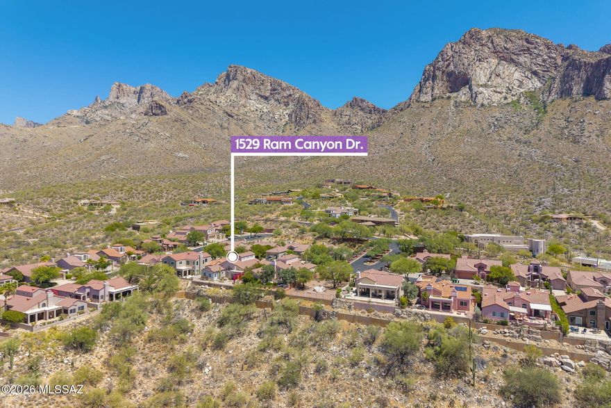 Home has over $100,000 updates, improvements. Primary Bedroom Suite is on Main level! Perched at the highest point on ''The Ridge'' of the prestigious guard-gated community of La Reserve, this truly one-of-a-kind contemporary residence offers a rare combination of dramatic natural beauty, sweeping panoramic vistas, and unforgettable city light views that few homes can rival. From rugged cliffs of the Pusch Ridge Mountain to endless layers of distant mountain ranges, glowing pink sunsets, and sparkling nighttime cityscapes stretching across the valley below, every window frames a breathtaking masterpiece. 
Privately tucked behind a charming front courtyard, the home welcomes you through a dramatic entry with soaring high ceilings, architectural details, and an impressive two-story fireplac that anchors the light-filled living room. Expansive windows bring the spectacular outdoors inside, creating a constantly changing backdrop of mountains, colorful sunsets, and twinkling evening city lights that make this home feel unlike any other.
Primary Bedroom Suite downstairs offers a peaceful retreat with direct patio access and incredible views, while the upstairs guest bedrooms, loft, bathroom and balcony vantage points capture some of the most mesmerizing day and nighttime city views imaginable. Whether enjoying morning coffee above the valley, watching monsoon storms roll across the mountains, colorful sunsets or relaxing under sparkling city lights at night, this property delivers an extraordinary lifestyle experience few homes can offer.
The thoughtfully updated 2,543 sq. ft. smart home has over $100,000 in improvements and updates and timeless architecture, including new flooring throughout ('21), whole-home water filtration and softener system ('21), Half Bathroom Remodel ('21) electric water heater with recirculating pump ('21), newer appliances ('21-'22), new gas fireplace log set ('22), new toilets ('21), complete polybutylene pipe replacement with PEX plumbing ('21), exterior and interior paint ('22 & '23), new Amarr 3-layer garage door ('23), 11 new windows ('24), new blackout shades in guest bedrooms, and new tile roof ('22) with a 20-year warranty.
The flexible den/dining/office space adjacent to the kitchen opens to an additional private courtyard, creating multiple indoor-outdoor living areas designed to embrace the surrounding scenery and Arizona lifestyle.
Located just minutes from the Golf Course, Hilton Resort with Tennis courts, Catalina State Park, hiking and biking trails, pickleball courts, dining, shopping, theaters, parks, fitness centers, the Oro Valley Aquatic Center, and world-class healthcare, this exceptional property offers a rare opportunity to experience luxury desert living with some of the most breathtaking views Oro Valley has to offer -- truly living on top of the world.