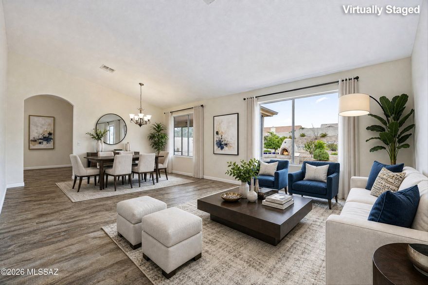 Located in SaddleBrooke's premier active adult community, this expanded Topaz model offers 3 bedrooms and 2 bathrooms with flexible living space. The family room features a cozy fireplace, plus a second outdoor fireplace for Arizona evenings. The 2nd bedroom serves as an office with a built-in Murphy bed, while the primary and 3rd bedroom include oversized walk-in closets. The spacious kitchen showcases granite countertops, a beautiful backsplash, breakfast bar, and eat-in area open to the family room. A welcoming foyer leads to a bright living room and formal dining space. Enjoy a screened-in patio on a third of an acre lot with room for a pool or casita. Updates include freshly painted interior & extended garage, new roof underlayment/recoated patio roof('25), owned solar, & no carpet.