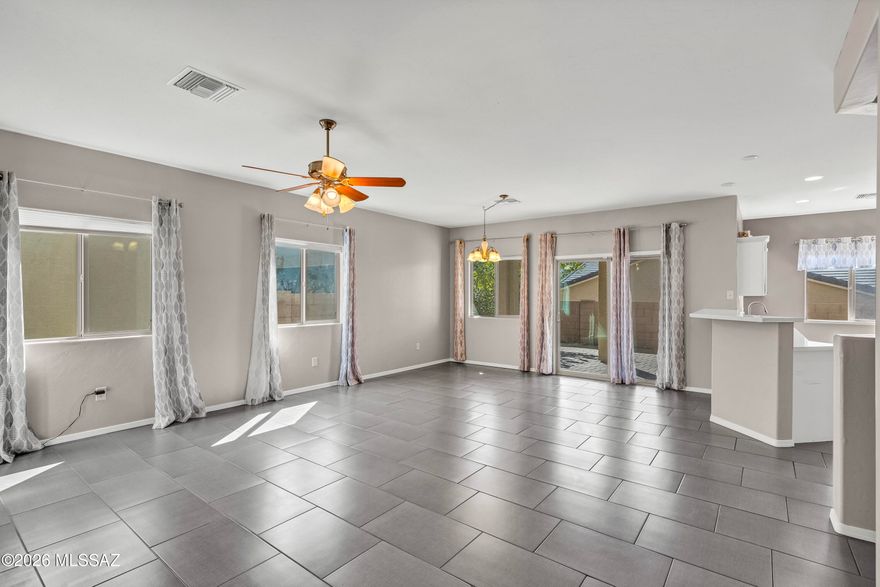 SELLER WILL CONSIDER OFFERS BETWEEN $340K-$360K. BEAUTIFUL 3 BEDROOM, 2 BATHROOM HOME LOCATED IN A GREAT SUBDIVISION. BUILT IN 2012. TILE ROOF.  LINEN-LOOK LARGE TILE FLOORING THROUGHOUT THE ENTIRE HOME IN 2024. QUARTZ COUNTERTOPS IN KITCHENS AND BATHS IN 2024.  STAINLESS STEEL APPLIANCE IN 2024. WASHER AND DRYER ARE INCLUDED. SPLIT BEDROOM FLOORPLAN. DESIGNER PAINT. LOW MAINTENANCE BACK YARD WITH PAVERS AND JACUZZI THAT TRANSFERS WITH THE PROPERTY (AS-IS).  EXCELLENT LOCATION WITH SHOPPING AND DINING AND ENTERTAINMENT AT NEARBY ARIZONA PAVILIONS. LOW ELECTRIC BILLS WITH SOLAR PANELS. LEASE MANAGED BY TESLA.