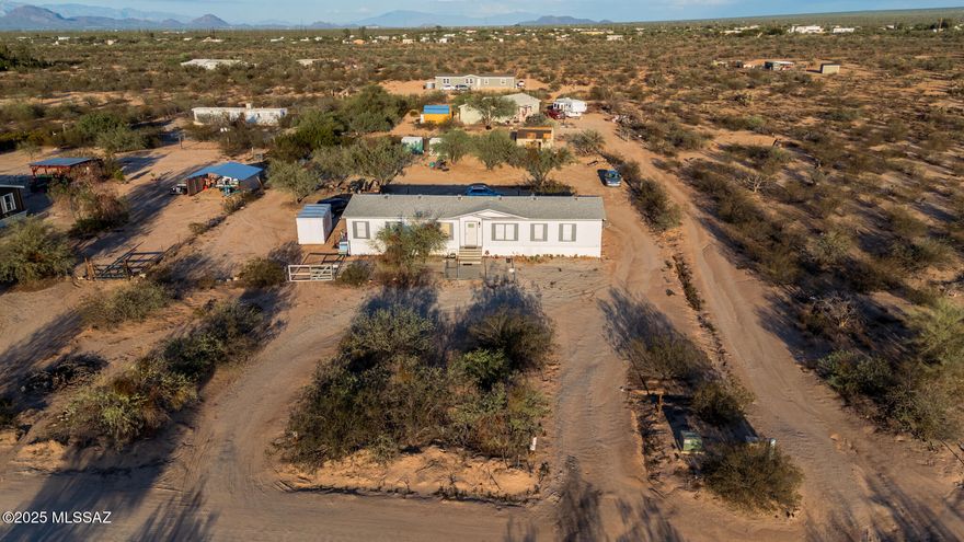 Beautiful 3 bed, 2.5 bath manufactured home on a full 1-acre lot in Three Points! Offering 2,128 sq. ft., this spacious split floor plan features a large open living area, oversized bedrooms with walk-in closets, and plenty of natural light. Take in breathtaking desert sunsets from the front yard and enjoy serene mountain views year-round. Built in 2000, this property has no HOA and is connected to city water, with plenty of space for horses, RV parking, and outdoor toys. Conveniently located just off Ajo Way with easy access to Tucson, this home blends peaceful country living with everyday convenience.