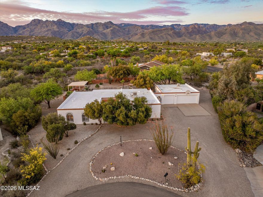 Welcome to your private desert resort in the heart of Sabino Vista, where timeless character meets modern living on over an acre of beautifully curated Sonoran landscape.

This renovated Spanish Territorial estate offers 3,237 sq. ft., featuring 4 bedrooms and 4 bathrooms, with the flexibility of a potential 5th bedroom or private office suite off of the garage.

From the moment you arrive, you're greeted by striking double iron gates that open into a charming courtyard, setting the tone for the warmth, elegance, and privacy that define this home. Inside, rich wood flooring, tile, and plush carpet blend seamlessly with plantation shutters and thoughtfully updated finishes throughout.

The layout is both functional and inviting, offering multiple living spaces including a spacious living room, formal dining area, and a versatile rec room complete with a bar, perfect for entertaining or unwinding. A small office tucked just off the laundry room adds convenience, while a separate office space off the garage (with its own bathroom) offers incredible flexibility for guests, work-from-home living, or a private casita-style retreat.

The primary suite is a true sanctuary, featuring its own private bath and direct access to the backyard, ideal for morning coffee or evening dips under the stars.

Step outside and prepare to fall in love.

The backyard is nothing short of spectacular, a true desert oasis designed for both relaxation and entertaining. Enjoy a sprawling covered patio, sparkling pool and Jacuzzi, outdoor fireplace, built-in barbecue area, and a gazebo with a wood-burning fire pit. All of this is set against breathtaking, panoramic views of the Catalina Mountains that feel almost unreal.

Additional highlights include:
" 3-car garage with EV charger
" Outdoor shower off of garage
" Mature fruit trees
" 1.1-acre lot offering privacy and space
" Close proximity to Sabino Canyon, Sabino Creek, hiking, golf, dining, and shopping

This is more than a home, it's a lifestyle. A rare blend of character, comfort, and resort-style living in one of Tucson's most sought-after areas.

Come experience the magic for yourself.