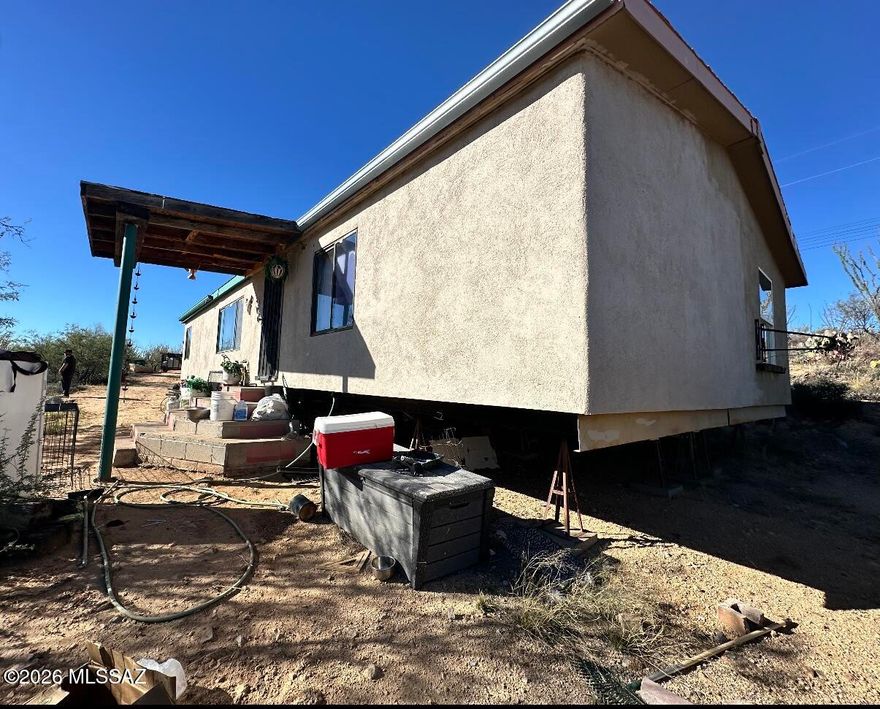 Deeply Discounted Investor Opportunity on 4.94 Acres in Sahuarita! Rare chance to secure a discounted property with major upside. 3 bed, 2 bath manufactured home (1,492 sqft) with existing utilities, septic, and hauled water. Features include mini-split system and tankless water heater. Home needs full renovation- ideal for fix & flip, rental, or land hold strategy. Private setting with wide-open desert views and no HOA. Cash or private financing only. Sold as-is. Strong value-add potential with room to expand, improve, or reposition. Don't miss this high-equity opportunity in a growing area.
Significant upside with rehab.