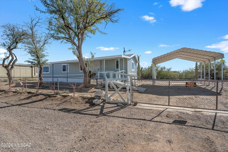 Cute as a button, this 3bedroom/2 bath home is clean and move-in ready!  This is a great opportunity to own a beautiful piece of land in Tucson's South West side of town with picturesque Mountain views and Saguaro studded streets! This home has been freshly painted inside and out, and sits on almost a half acre of usable space. Bright open spaces, vaulted ceilings, and a split bedroom floor plan giving everyone their own privacy. Laminate flooring throughout, new fixtures including ceiling fans and lighting. All appliances are included for convenience as well. Plant your gardens here, work on your cars, or just sit back and enjoy the Sunsets!  Covered parking and a fully fenced yard for privacy! All paved roads here, no dirt!  Come see why this home is your best next investment!