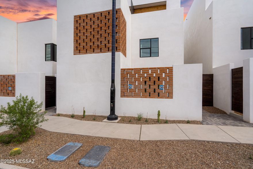 ASK US ABOUT 4.99% BUILDER RATE INCENTIVE! WE WILL PAY BUYERS CLOSING COST TOO! Welcome to the epitome of upscale urban living in Tucson's vibrant Five Points neighborhood, where modern sophistication meets historic charm. This is The Row at 18 W. 18th, an exclusive 16-unit desert contemporary townhome subdivision featuring a harmonious blend of luxury & location, boasting solid white, smooth stucco construction with authentic adobe brick accent walls. Meticulously designed by HA|RU architects, in collaboration with Durazo Construction, honors the ethos of Southern Arizona with clean lines and a contemporary eel that maximizes natural light, creating an open, and airy ambiance throughout each home. The kitchens are designed for style and functionality, complemented by custom Davis Kitchen cabinetry that embody superior craftsmanship and luxurious design. The primary bedrooms offer en-suite baths with custom closets by Classy Closets, offering ample storage solutions. These thoughtfully designed spaces are perfect for the discerning homeowner who values quality and attention to detail, captured throughout each space. Located in the heart of vibrant Five Points, where 5 historic and distinct neighborhoods meet, these townhomes offer unrivaled walkability and access to a plethora of amenities and authentic, local restaurants. Residents will enjoy a dynamic lifestyle with everything at their doorstep from artisan coffee shops to organic grocers, eclectic dining, and vibrant community events, all with a Walk Score of 84 and a Bike Score of 98. This is more than a home; it is a lifestyle rooted in convenience, culture, and modern luxury, seamlessly blending with the historical beauty of Tucson. Embrace the opportunity to live in a place where contemporary design and historic charm coexist in perfect harmony.