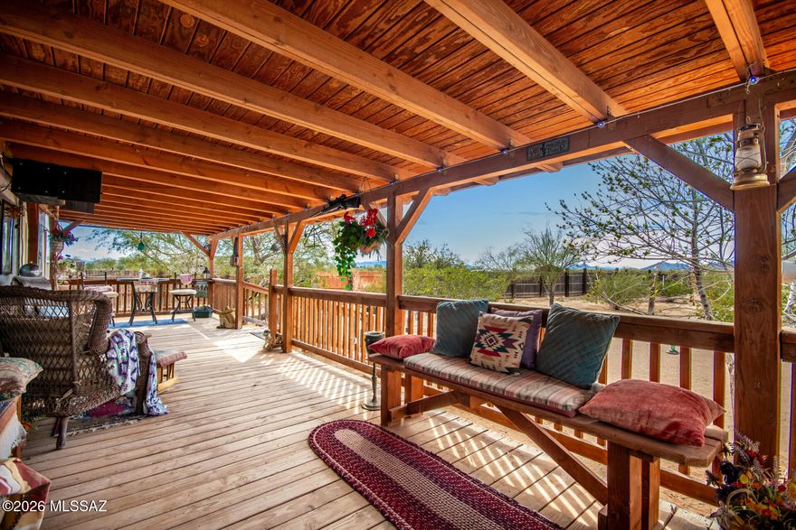 Panoramic mountain views and breathtaking sunsets from your front porch. Your private 5 acre retreat with room to breathe. Mature trees dot the fully fenced property with covered parking and a detached building housing both a garagae and a workshop -two separate spaces under one roof with owned solar power (runs refrigerators, freezers, and outlets with zero electric bills for your workspace). The raised mutli-dog kennel setup (''Puppy Palace'' accommadtes up to 5 dogs comfortably -perfect for breeders, rescues, or large pet families. 1,216 manufacutured home with a single level living. True seclusion with those daily mountain views and sunset shows. Rough road access ensures privacy and keeps casual traffic away. This is the property for buyers who want space, solar-powered workspace, and a setup built for projects, animals, and independence.