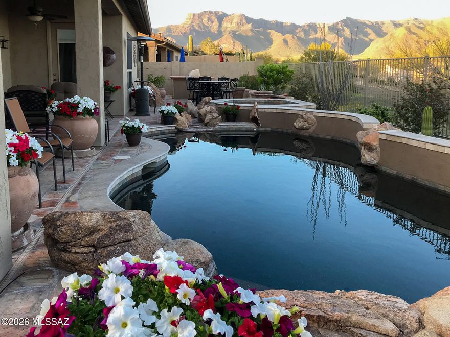 PRISTINELY maintained FULLY FURNISHED & TURN-KEY luxury home with private casita offering 3 bds, 3 bths + den & an exceptional 3-car garage. This home is nestled on a premium homesite in the QUIET Superstition Foothills neighborhood & features a heated lagoon style pool w/rock waterfall and spa, built-in BBQ, breathtaking mountain views, no home behind or in front, and even its own backyard grapevine. No need to bring anything -just move right in!
The gourmet kitchen is appointed with GE Profile appliances including a double oven and smooth-top range, granite countertops, Sub-Zero fridge, and wine cooler. Recent upgrades include a completely NEW roof (2023), most windows replaced to Andersen (2023), a fully remodeled owner's bath (2024), 3 new Toto toilets & A/C unit recently upgraded too Additional highlights include Hunter Douglas shades, 3 separate A/C systems for efficient comfort, an exquisite gas-burning fireplace, hot water recirc pump, soft water and R/O systems, security system, soaring 10' ceilings, and a newly replaced drip irrigation system. The dream garage is extra deep and wide with its own workshop, tool chest, and abundant storage. This home truly has it all -- luxury, views, privacy, comfort, and impeccable care throughout.